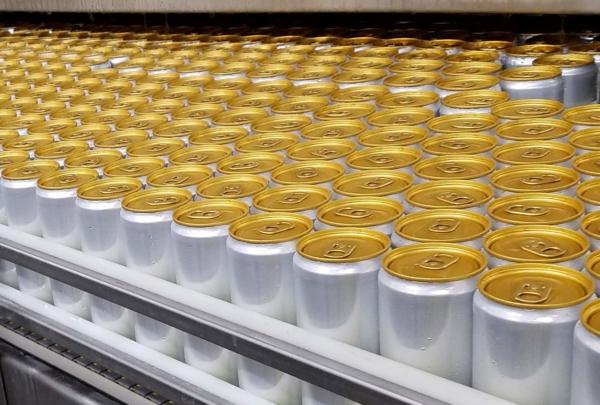 Filled seltzer cans await labeling